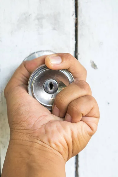 Hand on old door knobs, Open door knobs