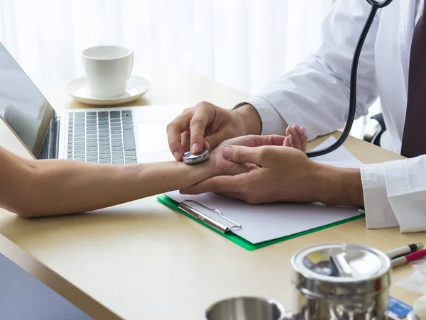 Close up of doctor hand reassuring her female patient at hospital. Closeup hands of medical doctor carefully holding patient\'s hands. Kind doctor giving real support for patient