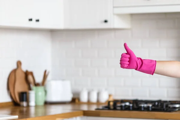 Mãos de mulher usando luvas de proteção no fundo da cozinha branca. Conceito de cozinha limpa, polegar bem sucedido sim sinal ok — Fotografia de Stock