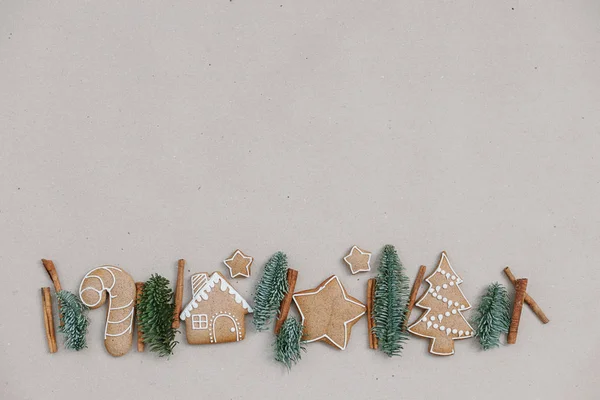 Christmas homemade gingerbread cookies in the line on craft paper background. Christmas bakery banner