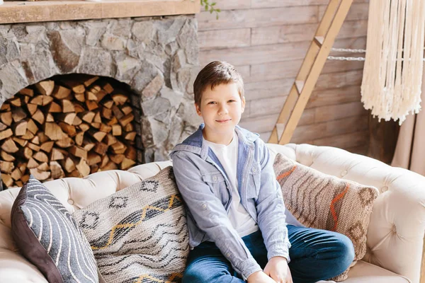 Portrait teenage caucasian boy sitting on couch at home — Stock Photo, Image