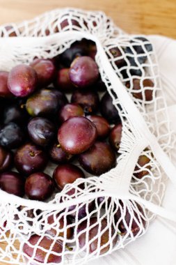 İp torbasındaki erikler masanın üzerinde. Sürdürülebilir mutfak, sürdürülebilir yaşam. Ev yapımı erik reçeli hazırlama