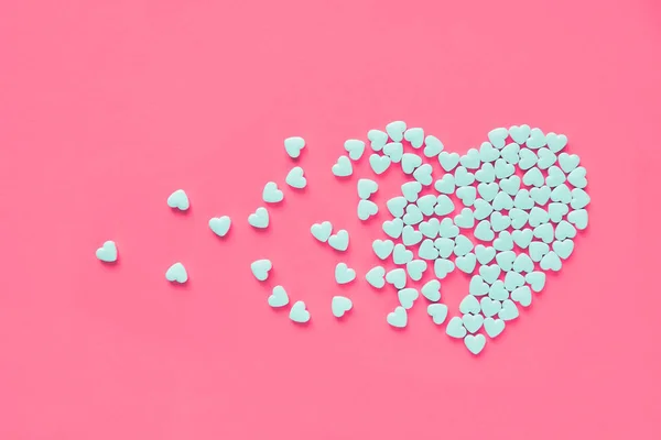Doces em forma de coração branco em um fundo de papel rosa. Coração partido ou pearts gethering conceito de amor . — Fotografia de Stock