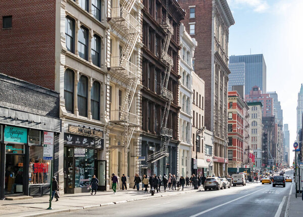 NEW YORK CITY, CIRCA 2018: People walk past the stores along Broadway in the SoHo neighborhood of Manhattan in New York City.
