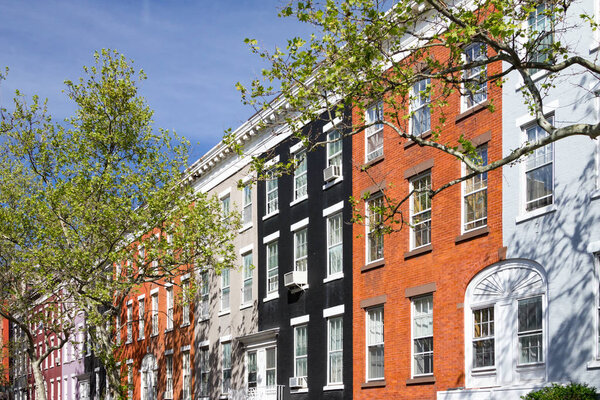 Block of colorful row houses on Macdougal Street in the Greenwich Village neighborhood in New York City