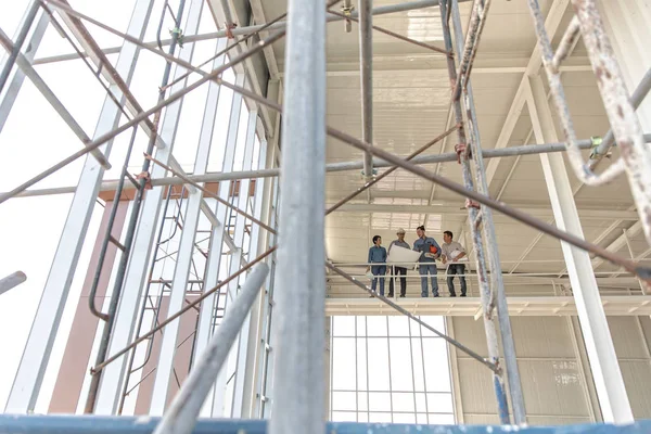 Gruppe von Ingenieuren, Mann und Frau, die im Konstrukt zusammenarbeiten — Stockfoto