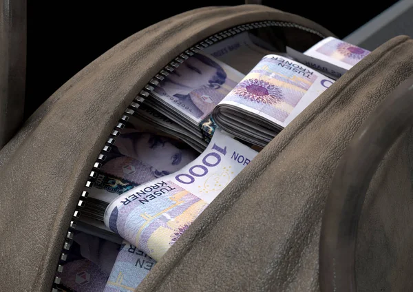 A smuggling concept depicting an open brown leather duffel bag revealing bundles of illicit rolled kroner notes - 3D render