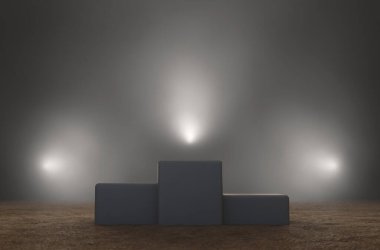 An empty classic winners podium on sand backlit by dramatic spot lights on a dark moody background - 3D render