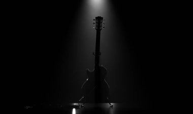 Bir müzik konseri sahnesinde dinlenen elektro gitarın asilüeti tek bir dramatik sahne ışığıyla aydınlatılıyor.