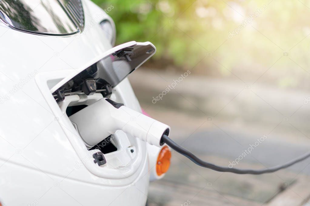 Bring Battery Chargers Connect with electric car To put the electric car into the car. Clean energy does not pollute the air. Energy conservation concept Alternative energy
