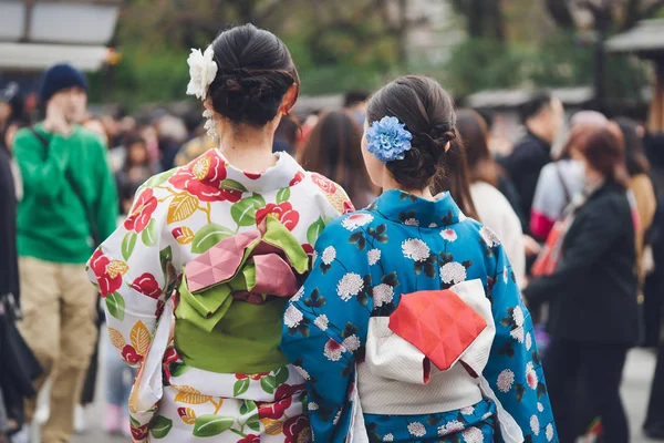 Young girl wearing Japanese kimono standing in front of Sensoji Temple in Tokyo, Japan. Kimono is a Japanese traditional garment. The word \