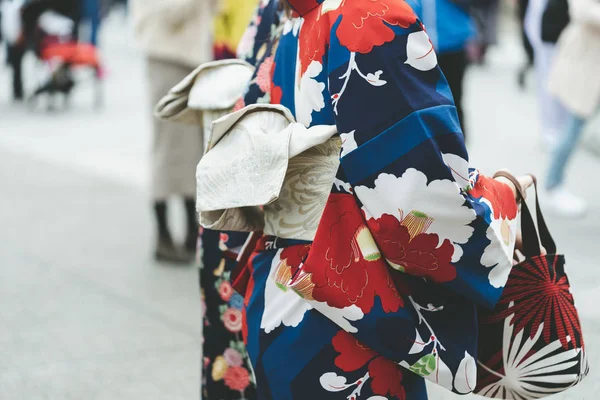 Young girl wearing Japanese kimono standing in front of Sensoji