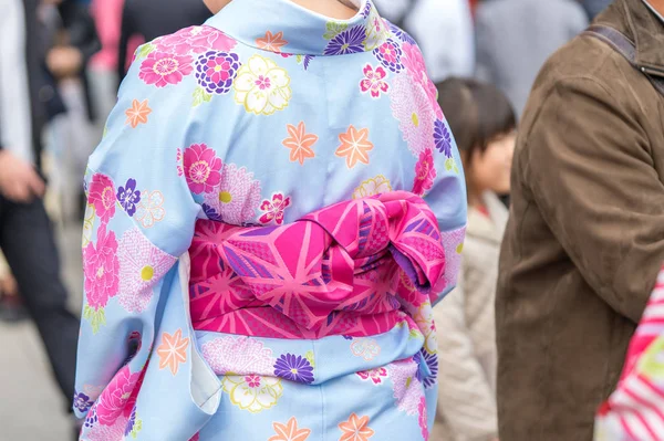 Young girl wearing Japanese kimono standing in front of Sensoji