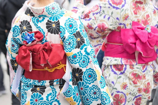 Young girl wearing Japanese kimono standing in front of Sensoji