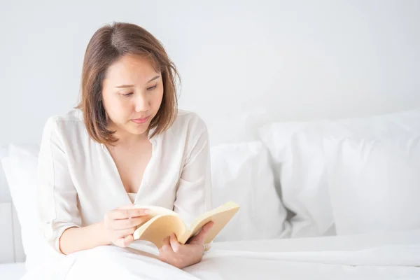 Asian girl Read books after waking up in the morning. It makes y