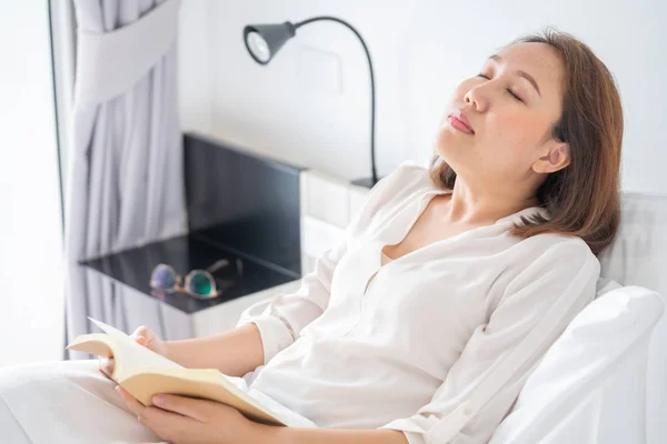 Asian girl Read books while sleeping. Man book cover Drowsiness