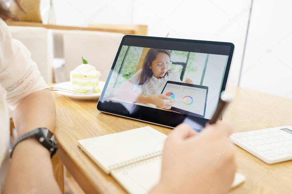 Asian woman aged 30-35 years using tablet, watching lesson online course communicate by conference video call from home, e-learning education concept