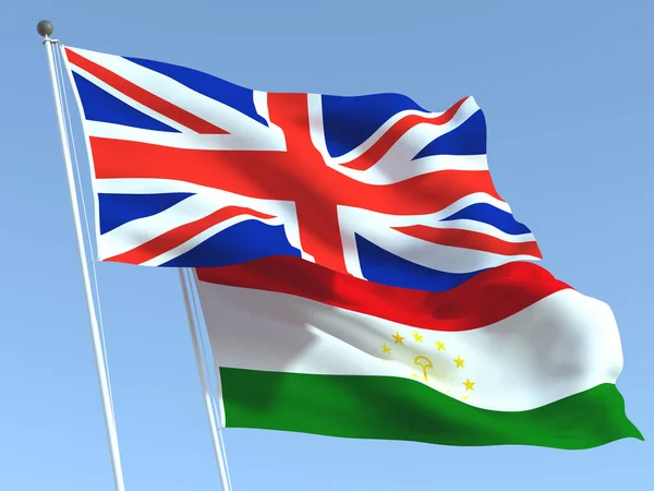 Dvě Vlající Vlajky Spojeného Království Tádžikistánu Modré Obloze Vysoce Kvalitní — Stock fotografie