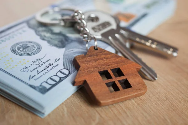 Real estate investing concept. American dollar, cash or housing. Keys close-up