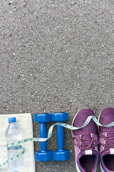 Measure tape covers sports items and bottle of water.