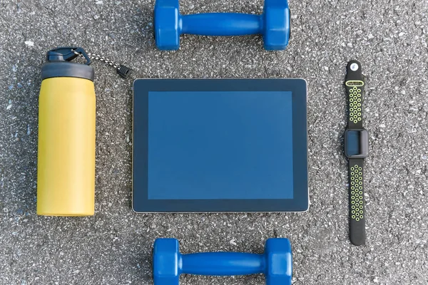 Smart sports gadgets. Cropped photo of dumbbells, water and smart watch