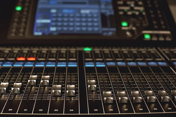 Digital Audio mixing console. Close-up view of professional equipment for sound mixing. Focus on audio control buttons