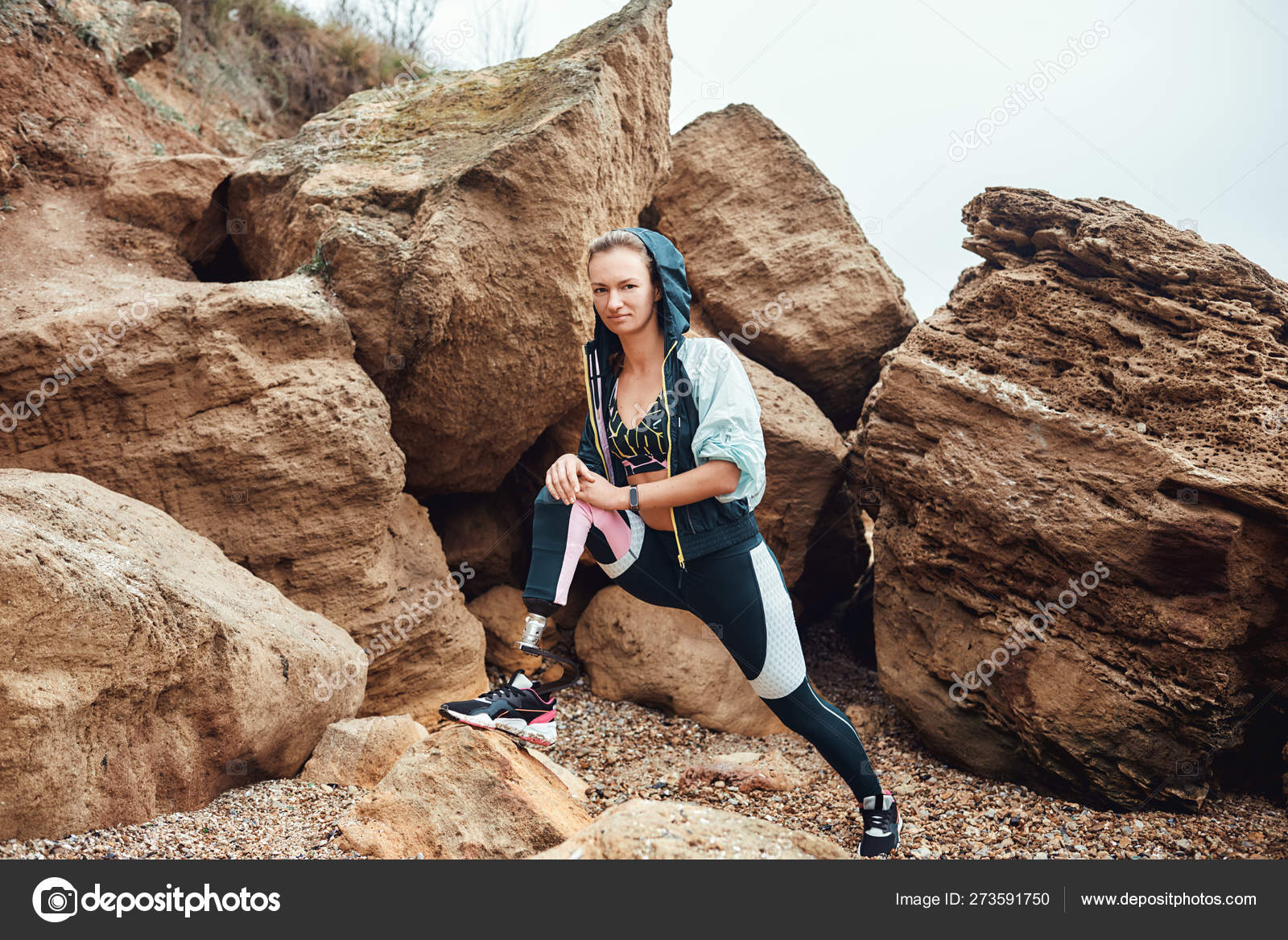 Sport is my way of life. Beautiful and young disabled athlete woman in  sportswear with prosthetic leg standing on the beach after morning workout  and looking at camera. Stock Photo by ©dima_sidelnikov