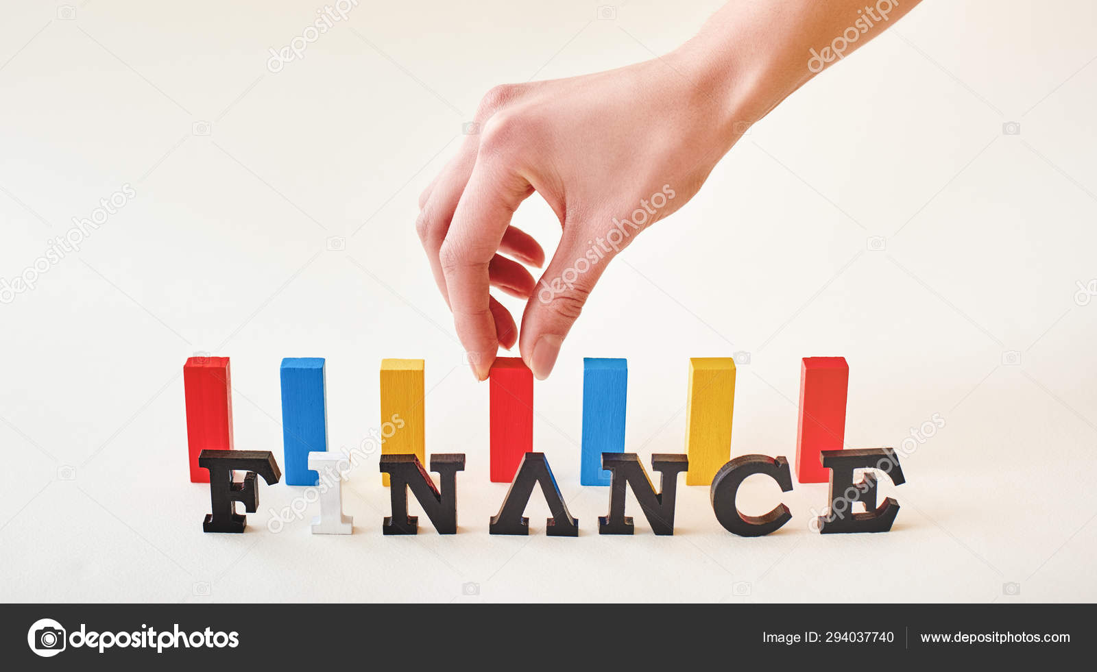 Finance word created with alphabet letters. Hand placing multi-colored ...