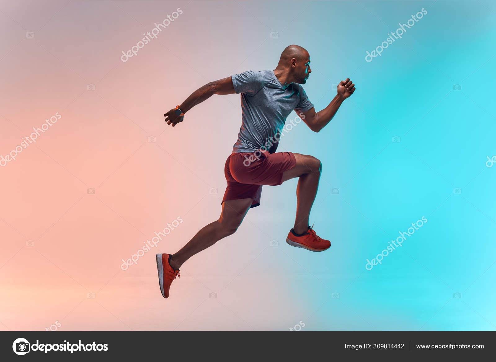 New champion. Full length of young african man sports jumping against colorful background Stock Photo by