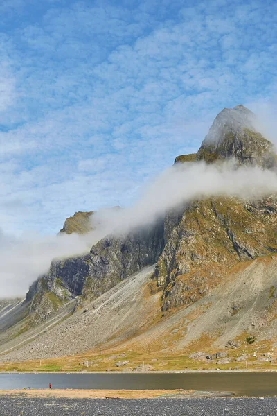 Foggy mood. Amazing shot of impressive Eystrahorn mountain chain in Iceland with fog rings around, blue sky on the background