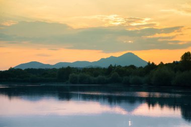 Göl, dağ ve orman ile bir güzel, renkli günbatımı manzara. Yaz aylarında dağ Gölü üzerinde doğal akşam sahne. Tatra Dağları Slovakya, Europe.