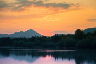 Göl, dağ ve orman ile bir güzel, renkli günbatımı manzara. Yaz aylarında dağ Gölü üzerinde doğal akşam sahne. Tatra Dağları Slovakya, Europe.