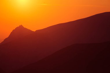 Güzel bir minimalist manzara sıcak tonları dağlarda üzerinde gündoğumu sırasında. Soyut, renkli sabah dağlarda toplayan. Tatra Dağları Slovakya, Europe.