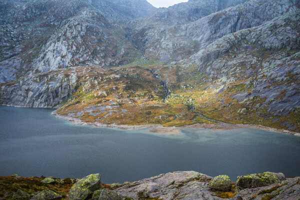 A beautiful landscape of a mountain lake in Folgefonna National Park in Norway. Overcast autumn day in mountains. Autumn scenery of lake.