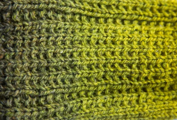 A beautiful closeup of a warm knitted pattern. Natural sheep wool yarn. Handcraft in bright colors.