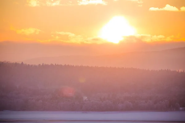 A beatiful sunset landscape of a small Norwegian ton Roros. WInter scenery with an evening sun. Warm, relaxing atmosphere.