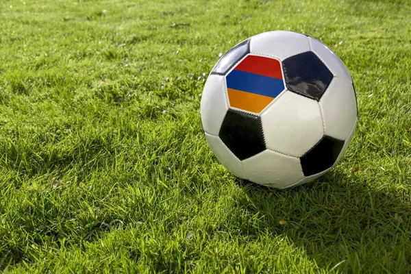 足球在草地上与亚美尼亚国旗 — 图库照片