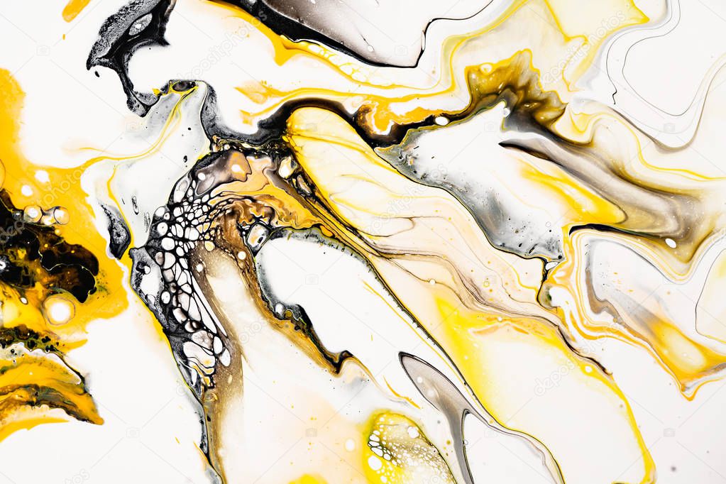 Mixture of acrylic paints. Modern artwork. Yellow and black mixed acrylic paints. Liquid marble texture. Applicable for design packaging, labels, business cards, and interactive web backgrounds