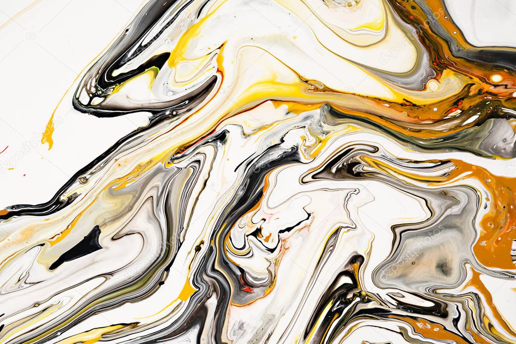 Mixture of acrylic paints. Modern artwork. Yellow and black mixed acrylic paints. Liquid marble texture. Applicable for design packaging, labels, business cards, and interactive web backgrounds