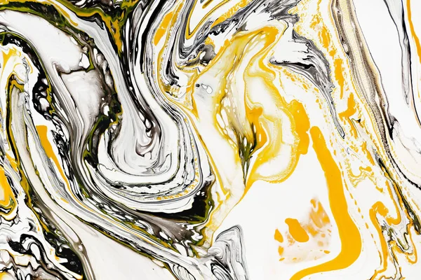 Mixture of acrylic paints. Modern artwork. Yellow and black mixed acrylic paints. Liquid marble texture. Applicable for design packaging, labels, business cards, and interactive web backgrounds.