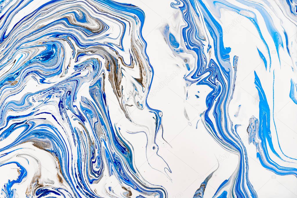Hand painted background with mixed liquid blue, white, yellow paints. Abstract fluid acrylic painting. Applicable for packaging, invitation, textile, wallpaper, design of different surfaces