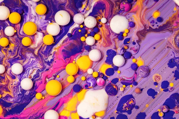 Acrylic paint balls abstract texture. Purple, blue and yellow liquids mix. Creative multicolor background. Bright colors fluid, flowing wallpaper design. Mixed pigments colourful backdrop. — Stock Photo, Image