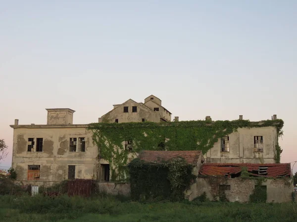 Abandoned factory, an old factory in total abandonment left there with nature that slowly covers it all and takes its spaces back