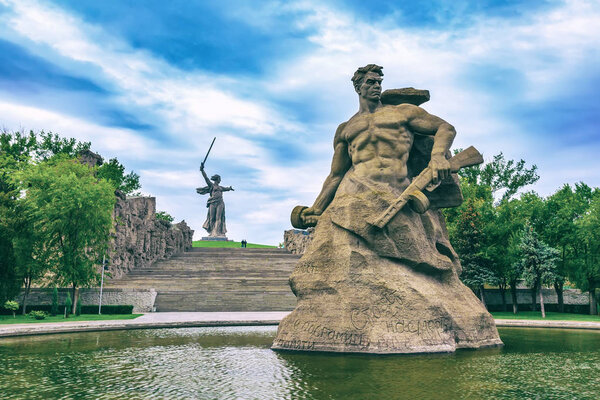 Monument Stay to the Death on square in honor of the Second World War, Motherland Calls rises on top of a hill, cold art green color toning. Memorial Mamayev Kurgan, Volgograd, Russia - August 2014.
