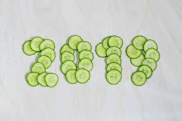 New Year's collage, healthy way of life, figures from cucumber
