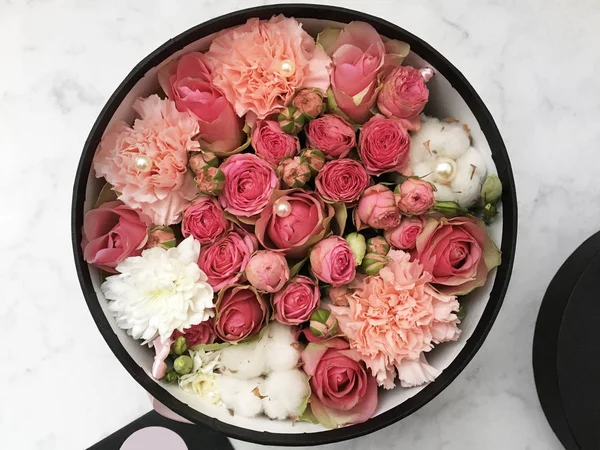 Flowers in a box and colorful almond cookies