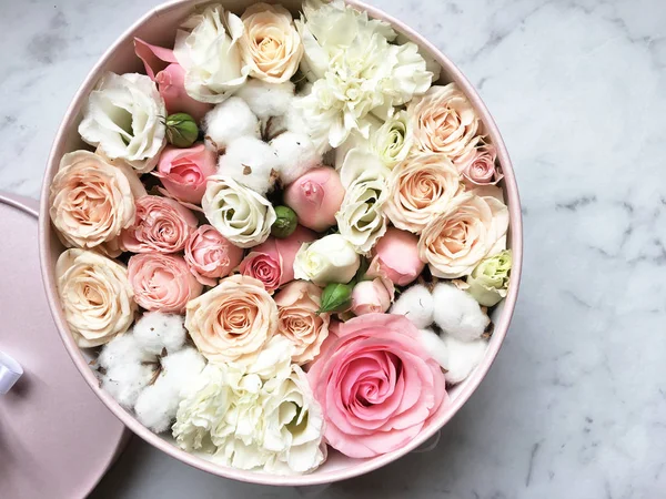 Flowers in a box roses and colorful macaroons macaroni marshmallow cotton