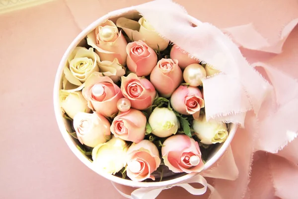 Flowers in a box roses and colorful macaroons macaroni marshmallow cotton