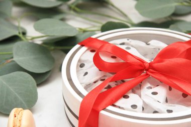 Güzel parlak kırmızı gül yaprakları beyaz arka plan üzerinde. Sevgililer günün kutlu olsun. Beyaz kutu kırmızı yay ile. Hediyelik