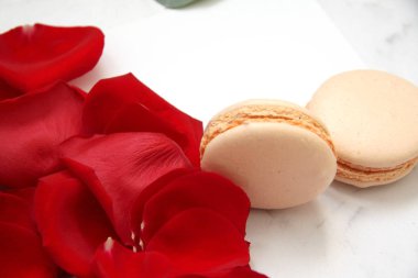 Gül yaprakları, kartpostal ve macaroons beyaz üzerine yapılan kalp